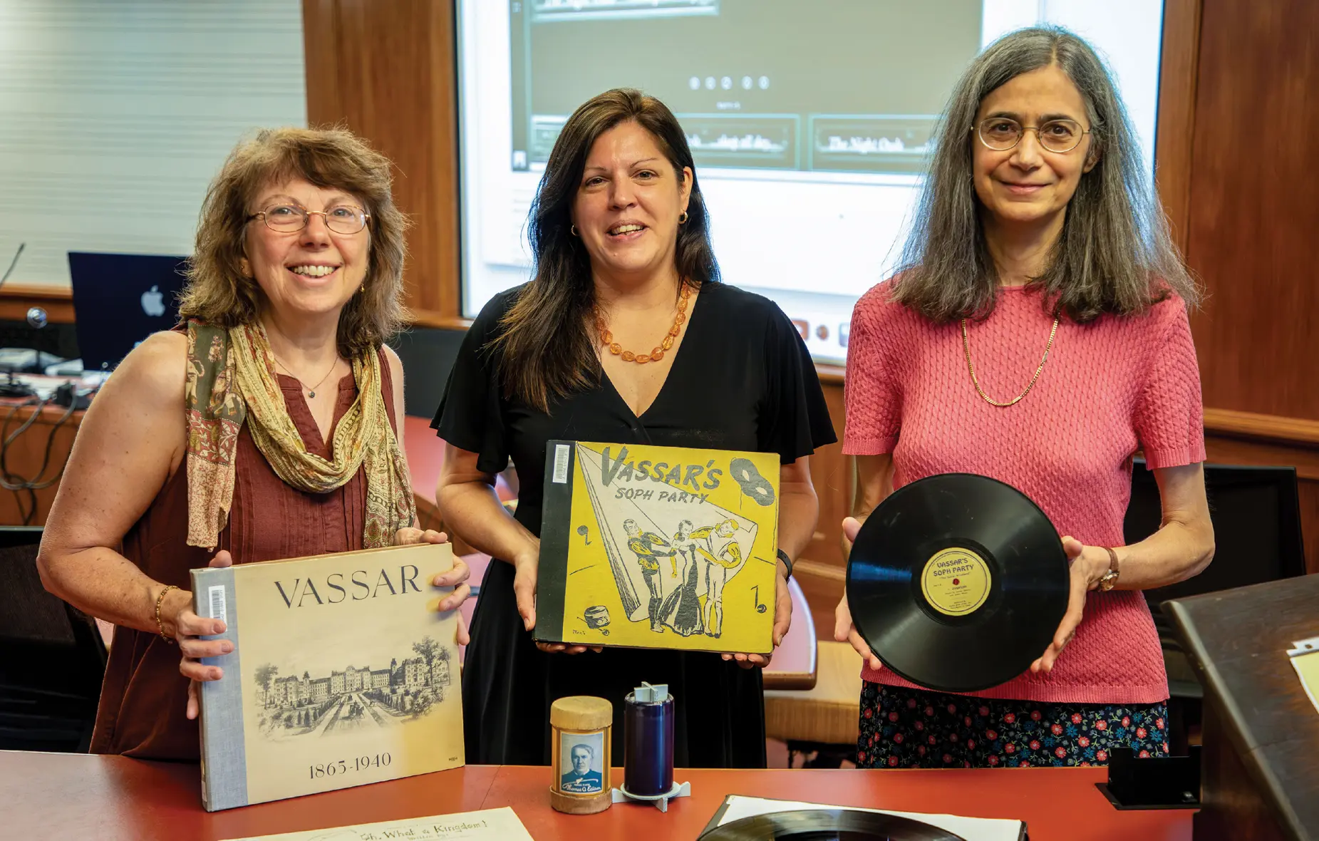 Sarah Canino, Nicole Scalessa with Ann Churukian smiling holing vinyl records