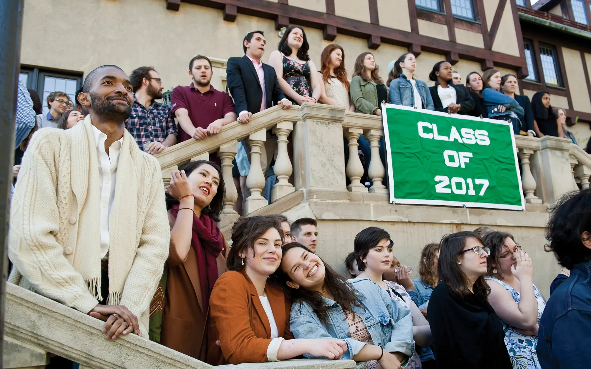Students gathered outside alumnae house with Class of 2017 green banner