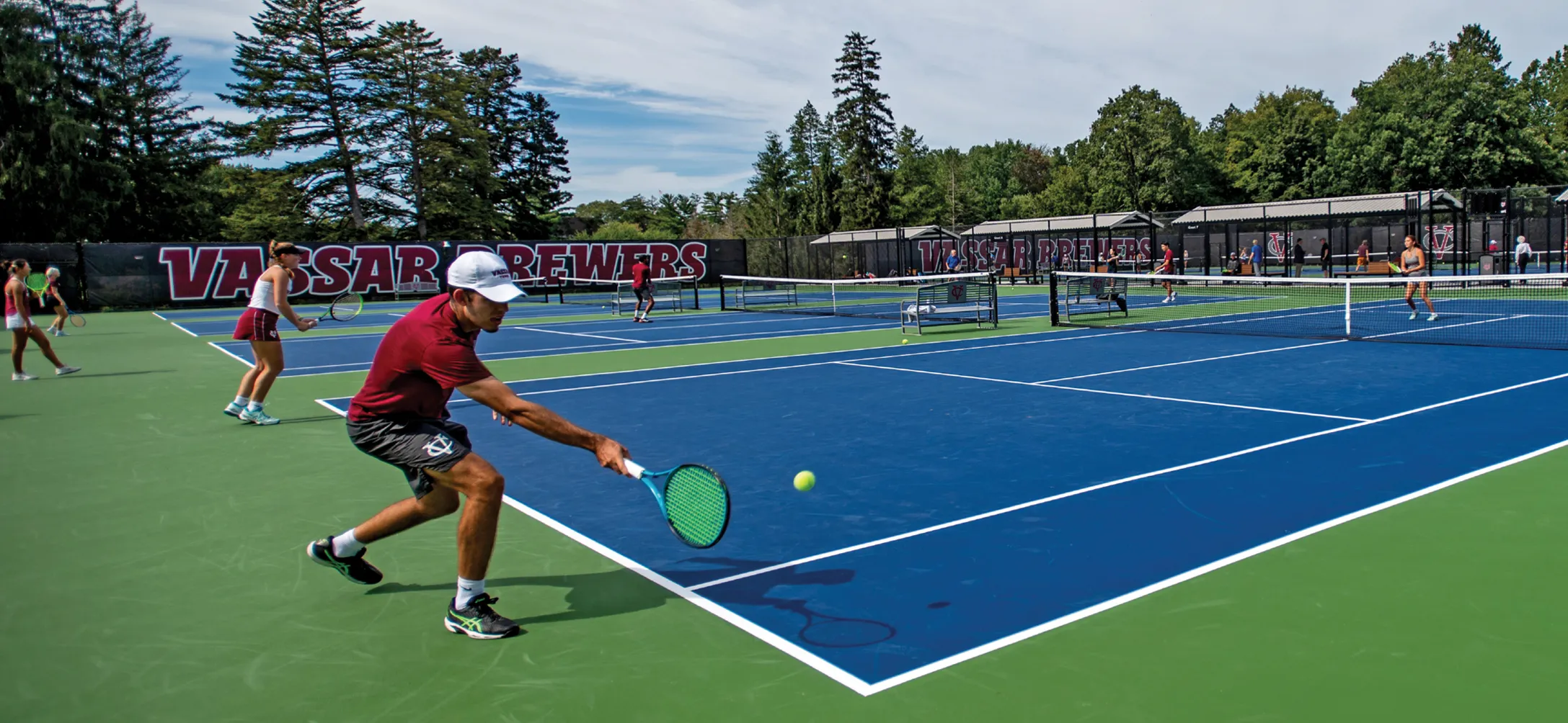 Tennis players in mid game on tennis court