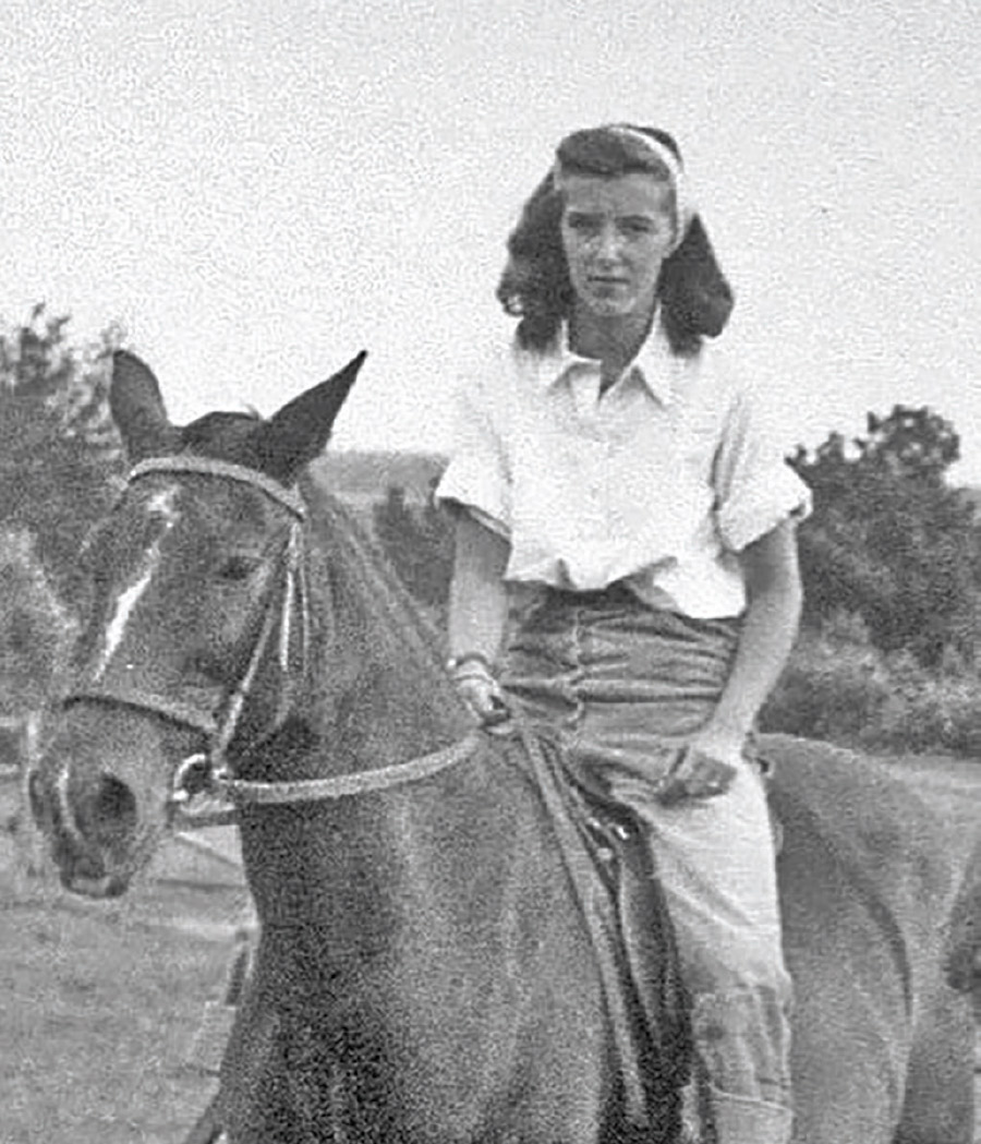Jan Farrington as a young woman riding horseback at camp.