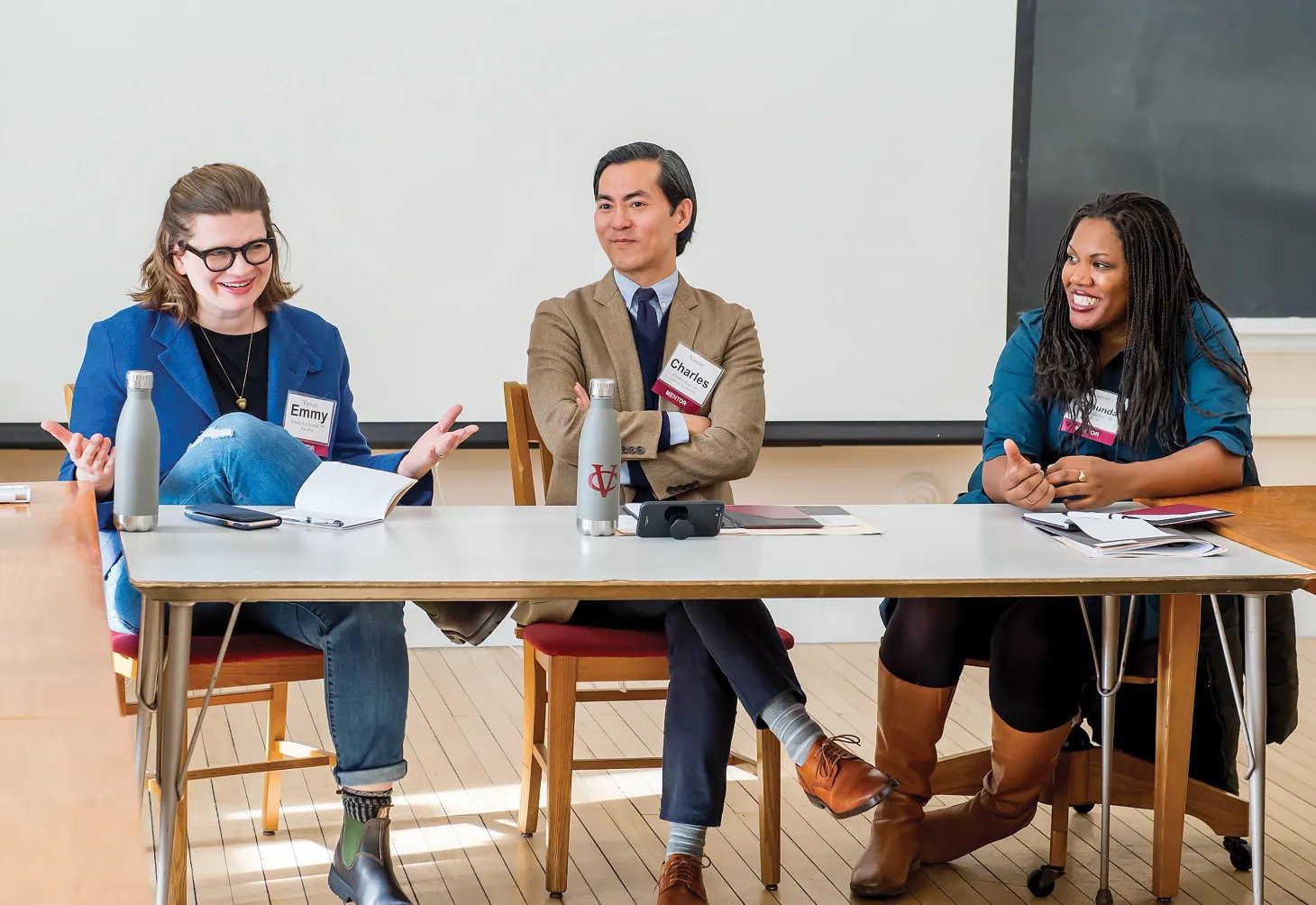 Three alums, including Charles Kim, class of 92, and Joshunda Sanders, class of 2000, at a table during a panel at Sophomore Career Connections.