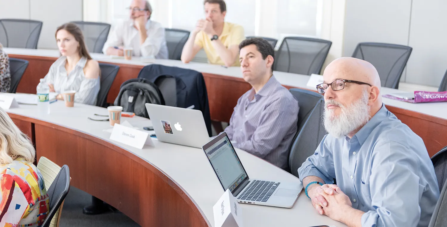 people attending a class and sitting in a lecture hall