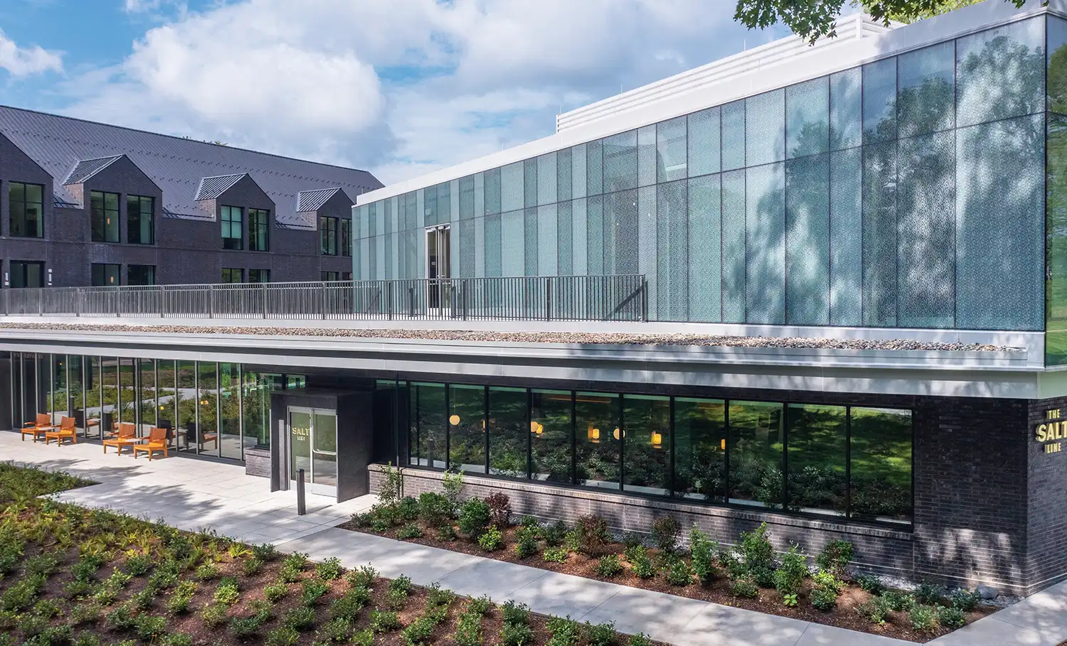 Exterior of the Vassar Institute for the Liberal Arts, housed in a modern building with glass walls.