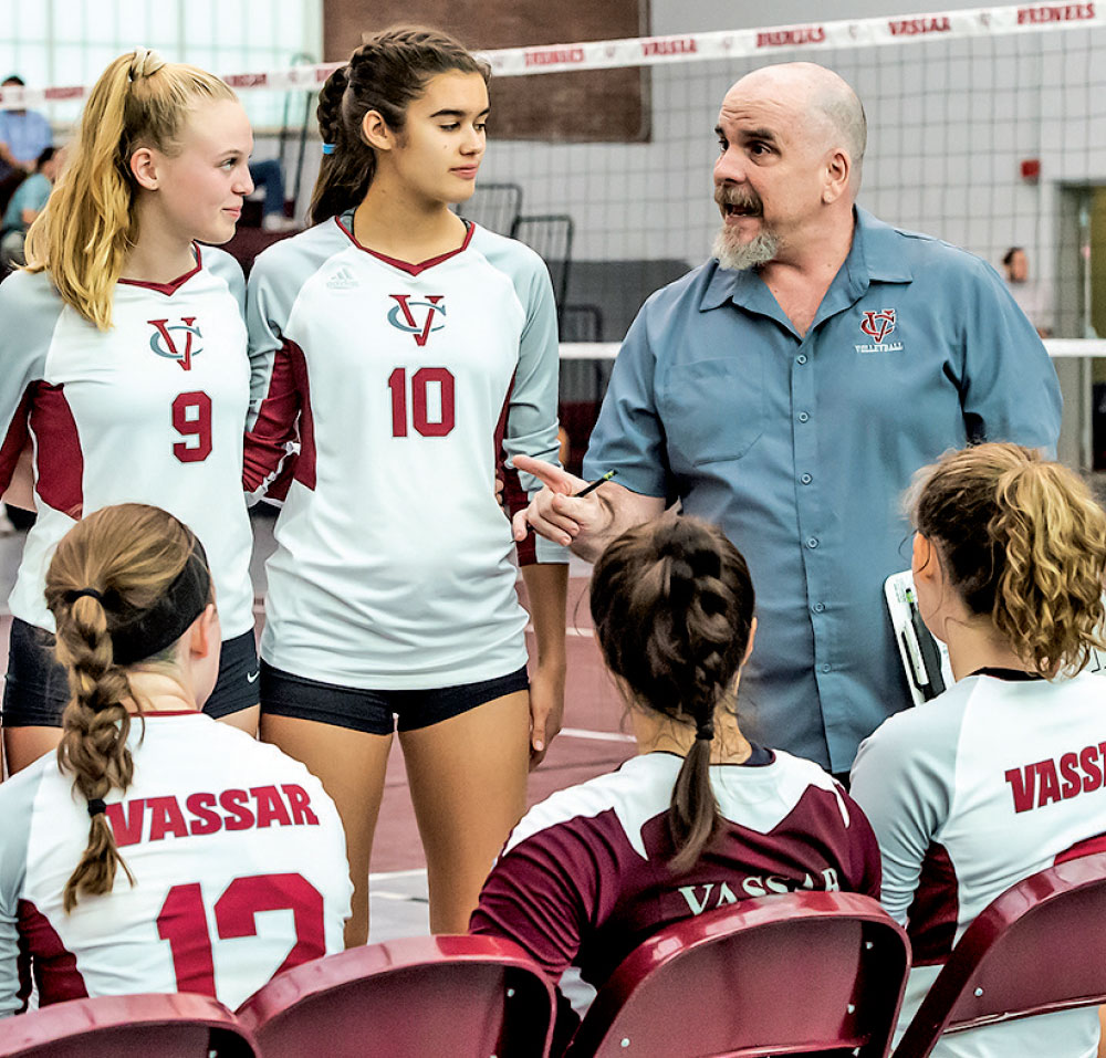 Retired coach Johnathan Penn gives pointers to the women’s volleyball team.