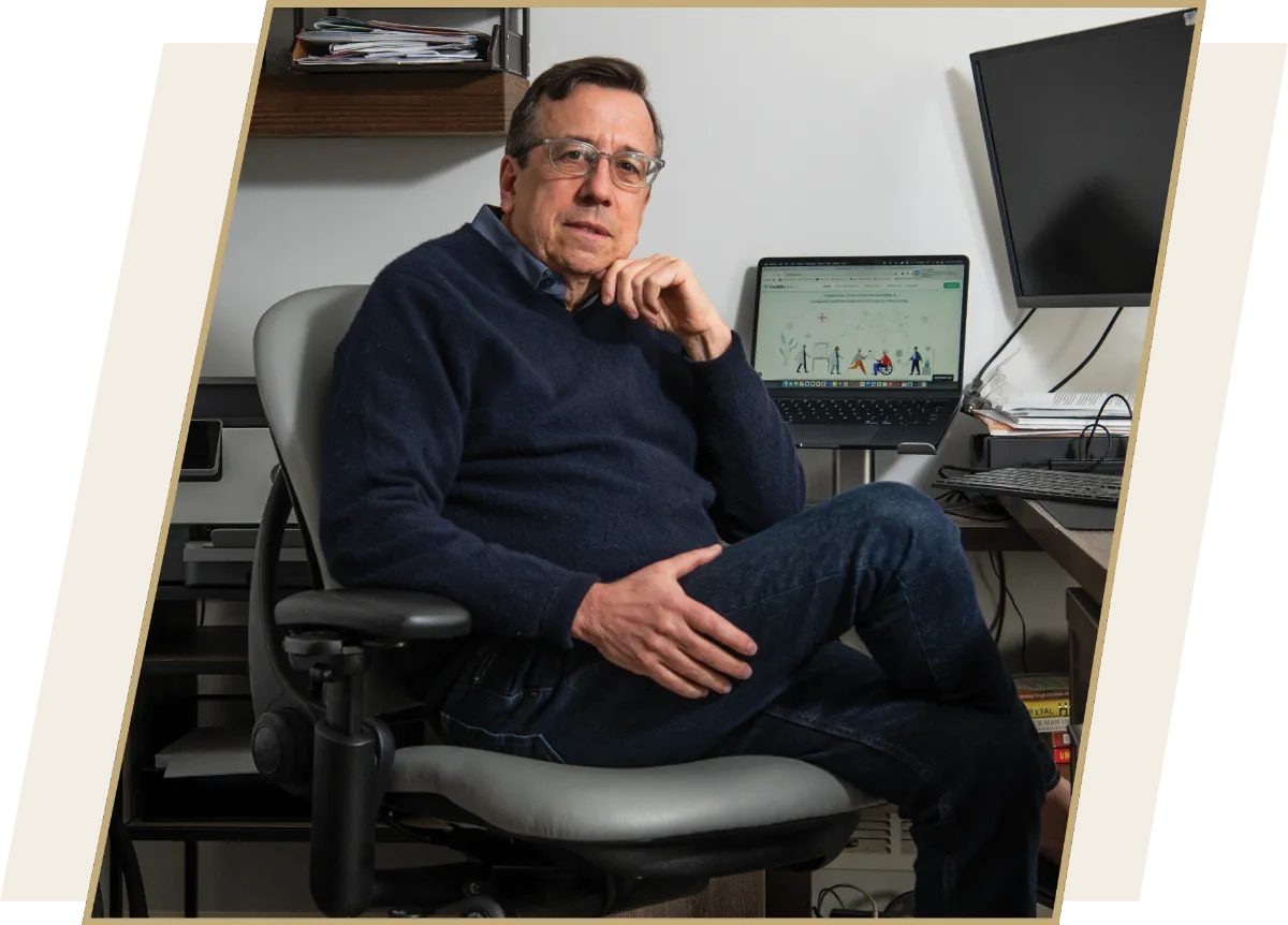  Stephen Farber (’84), CEO and Co-founder of Healthive and PBC, sits in front of a computer in his office.