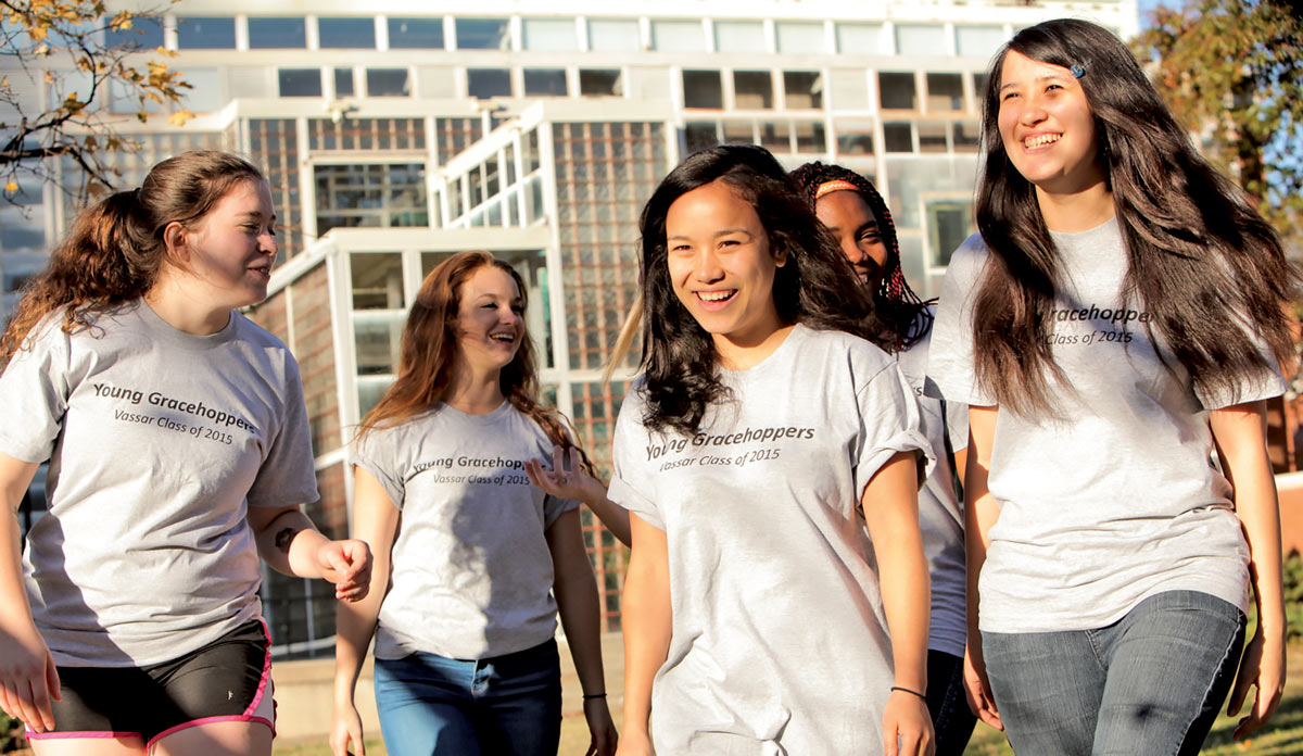 A group of young women walk together proudly as part of the “Young Gracehoppers” coding group.