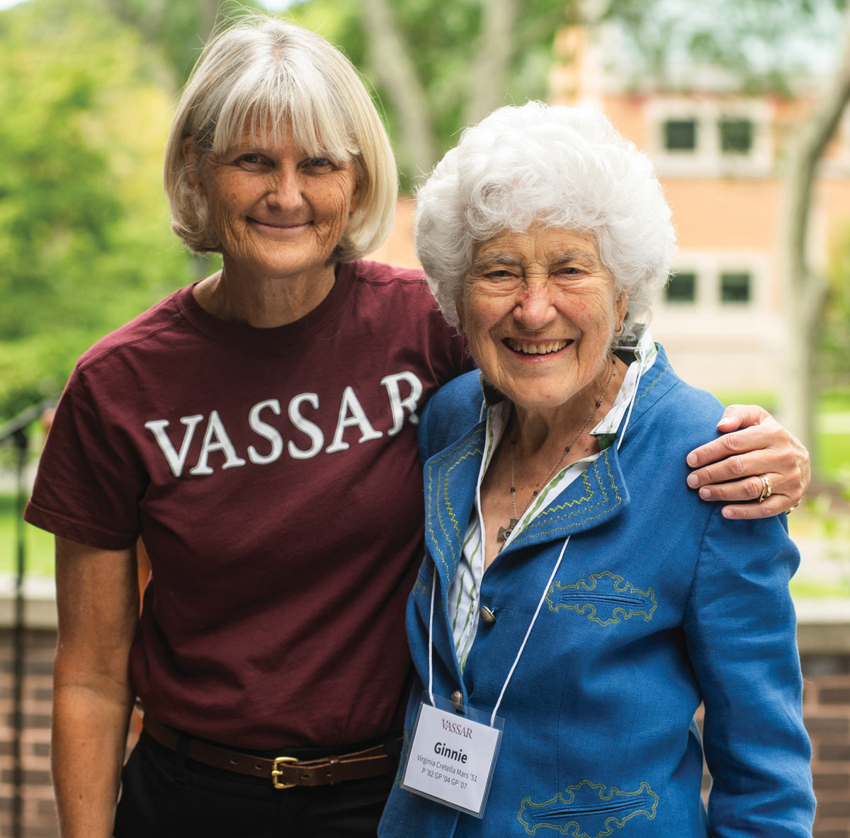 President Bradley, in a red Vassar t-shirt, hugs the late Virginia “Ginnie” 