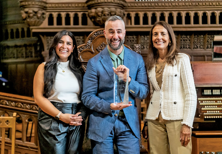 David Ambroz (’02) poses with AAVC President Monica Vachher (’77) and Stephanie Goldberg (’14) after being awarded the AAVC 2024 Spirit of Vassar Award. 