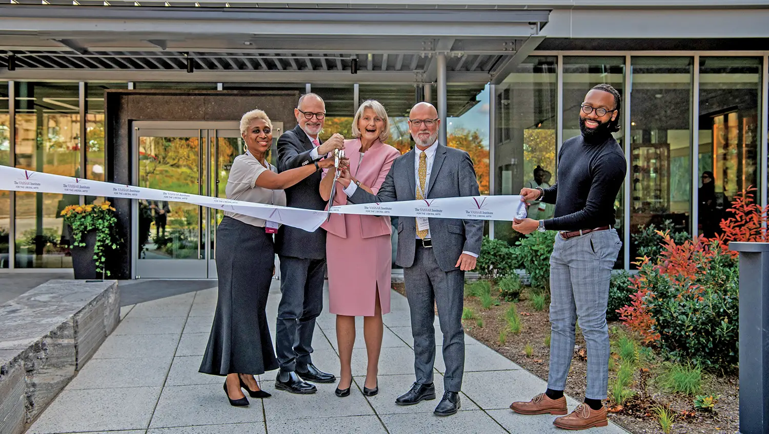 Outside the Heartwood facility, President Bradley and 3 others cut a white ribbon during the launch of the Vassar Institute for the Liberal Arts.