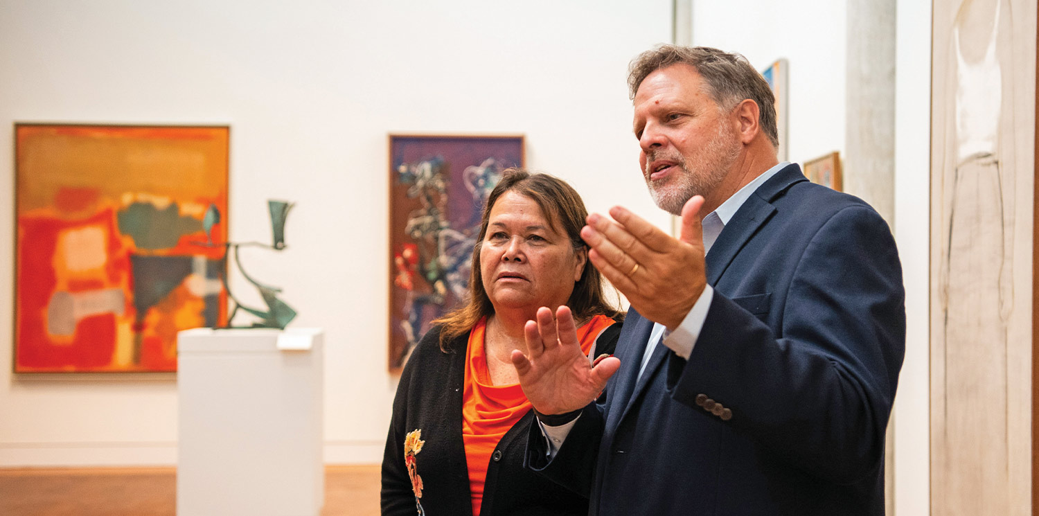 Stockbridge-Munsee Tribal Liaison Sherry White views an exhibition of Native American art with Loeb Director, Bart Thurber.