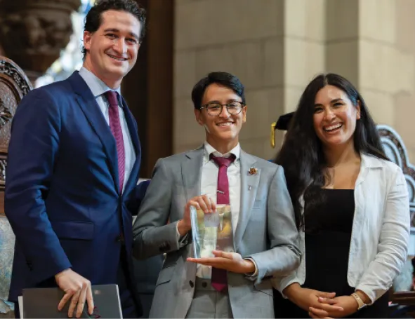 Three Vassar alums stand together in business attire after winning one of the AAVC Alum Recognition Committee’s awards.