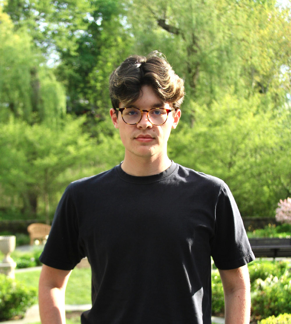 A portrait of Connor Dalgaard ’26 with trees in the background.