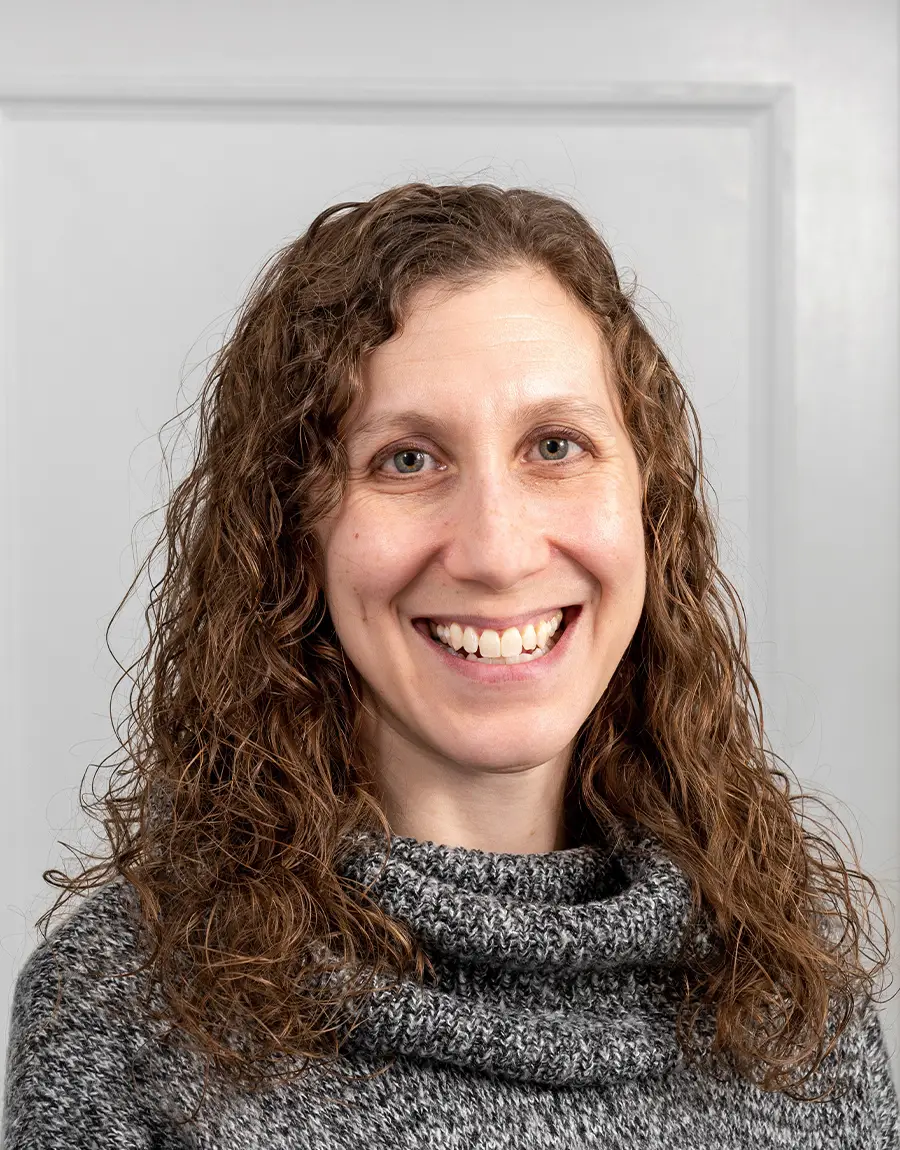 A portrait of Wendy Freedman, Director of the Counseling Service, wearing a grey turtleneck sweater.