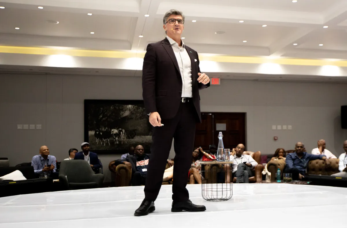 Minerva Tantoco ‘86 stands at a microphone during a keynote address.