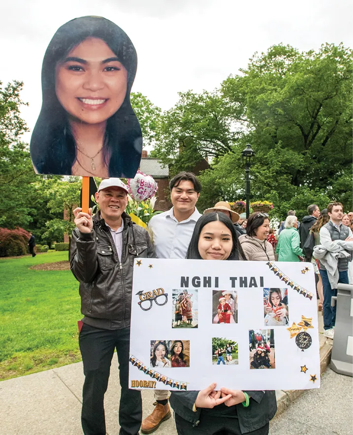 Nghi Thai ‘25’s family holds up celebratory posters.