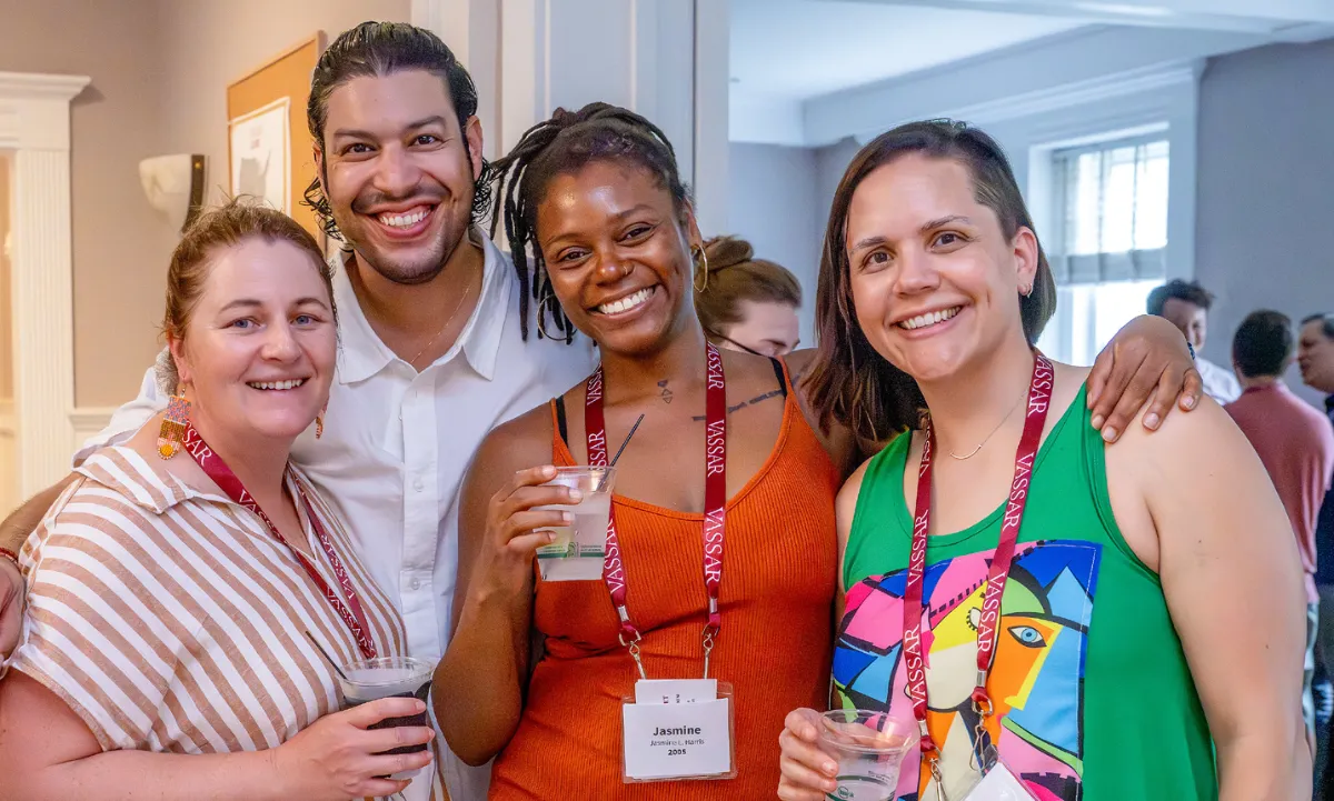 Portrait of four Vassar alums socializing.