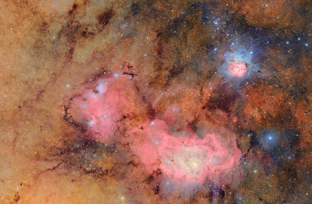 The Trifid and Lagoon nebulas in space.