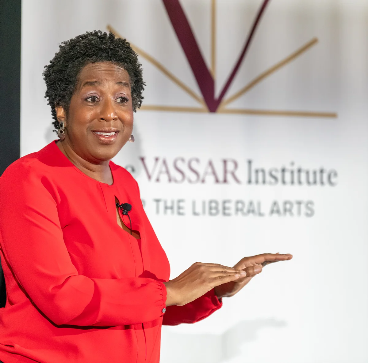 Doreen Oliver mid-performance, hands outstretched.