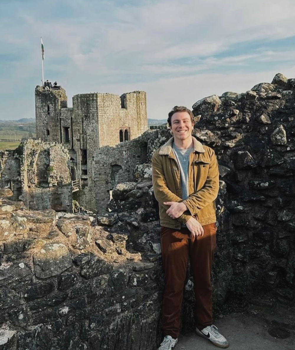 Cody Siegel ’26, standing in front of the ruins of a Welch castle.