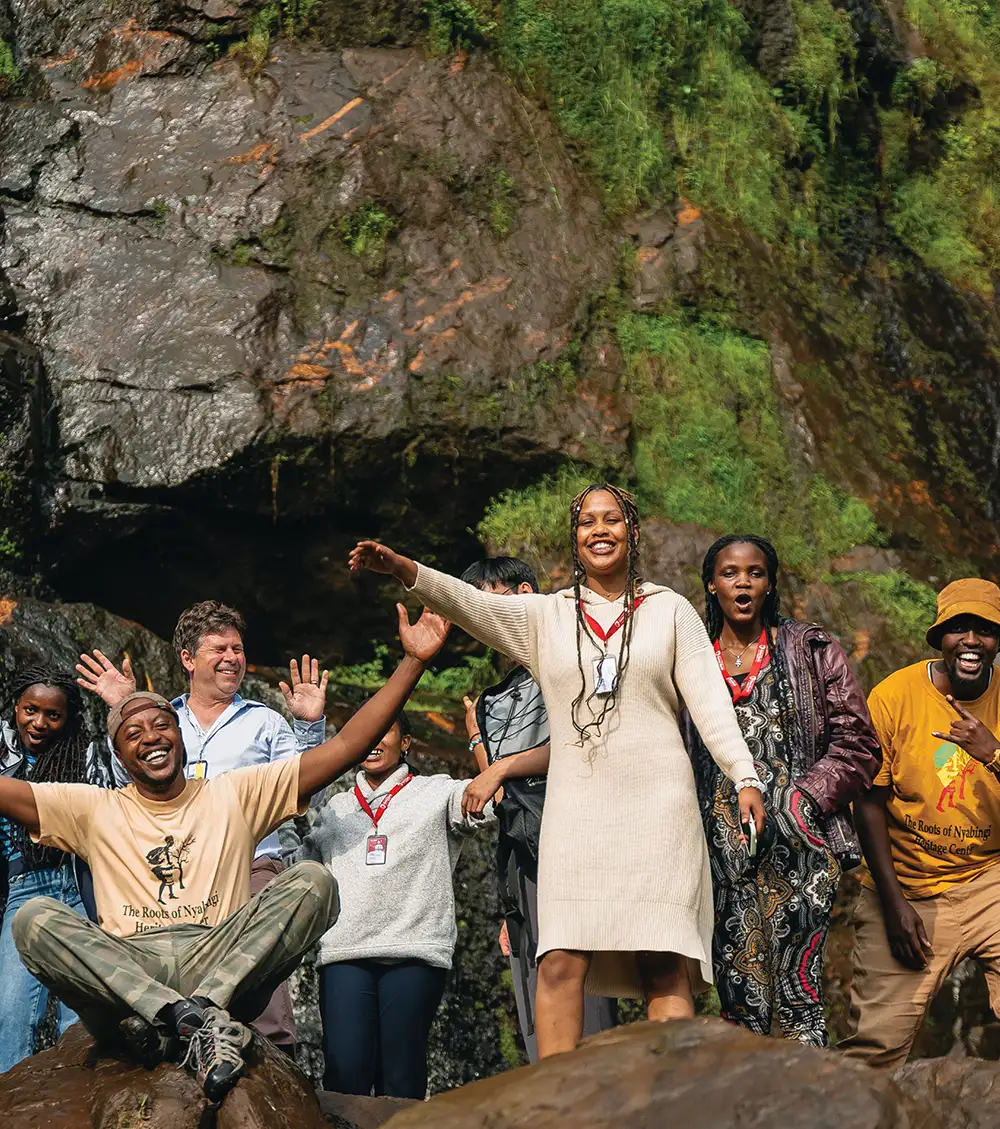 Professor Thomas Parker and several students posing on a rocky mountainside in Rwanda.