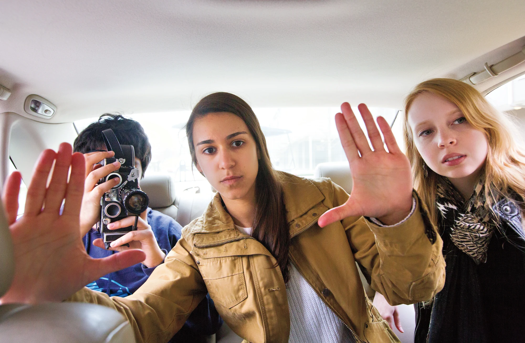 Three women sitting in a car.