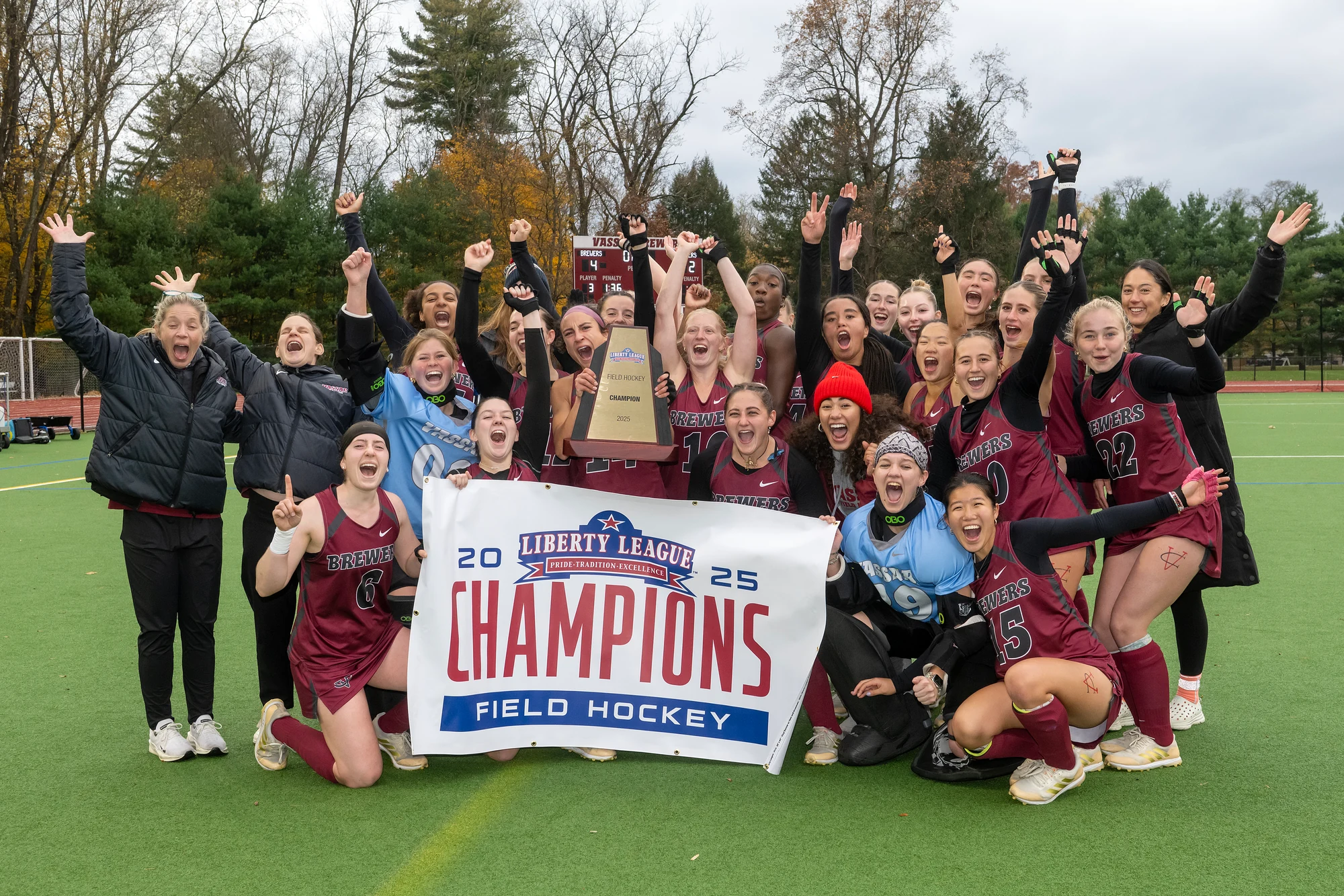 A group of women holding up a banner that says "Champions".