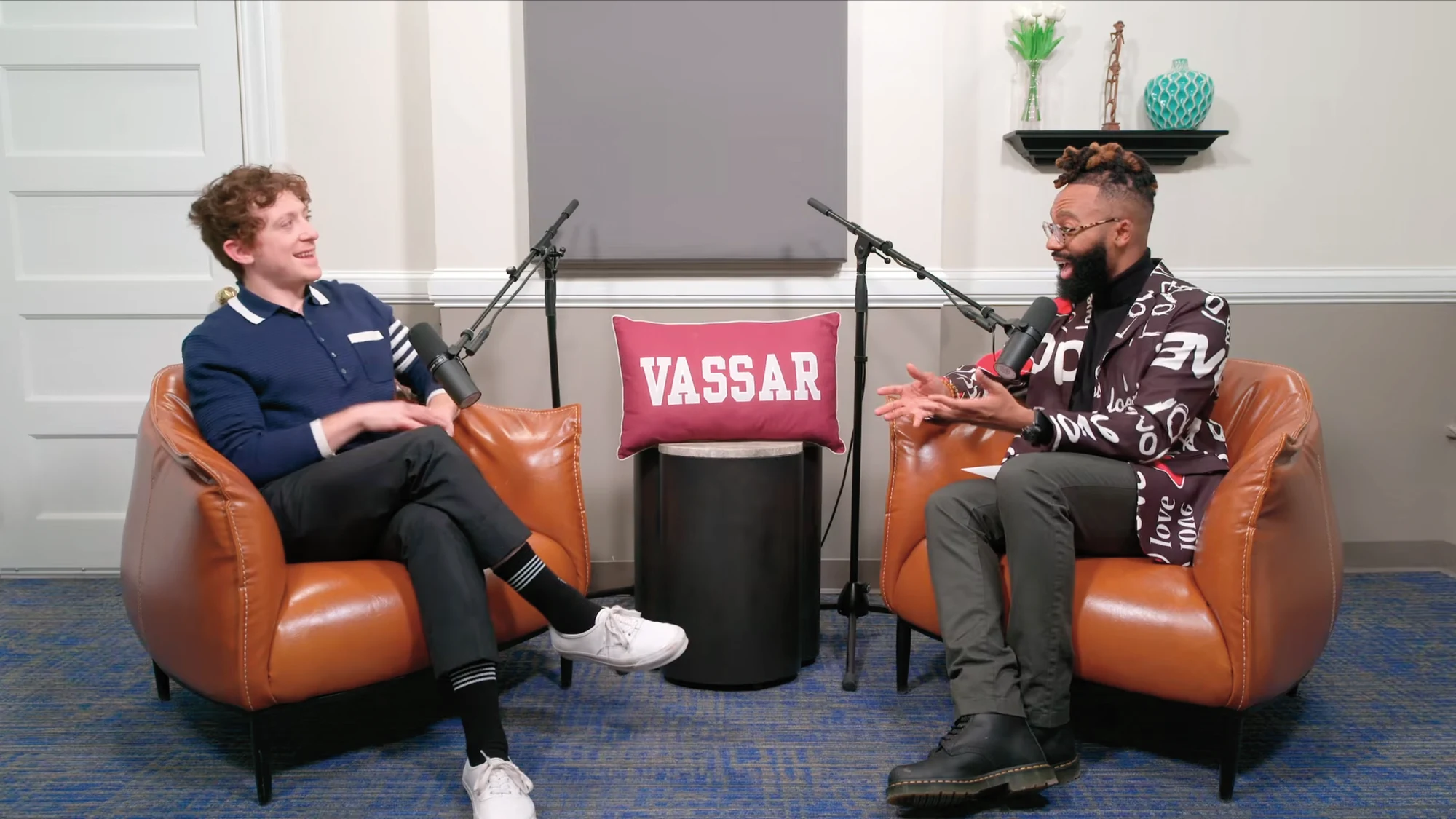 Two men sitting in chairs talking.
